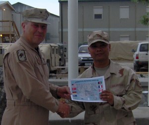 Air Force NCO getting his certificate for completing the 1st ever Freedom Run from the General in front of the BAF flagpoles. He had no idea we made it up.