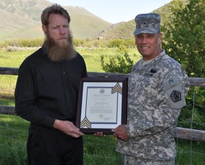 Brig. Gen. Rick Mustion, the adjutant general of the U.S. Army, presents Sgt. Bowe Bergdahl's promotion certificate Bergdahl's father but if he was a POW and out of the DoD system is it legal?
