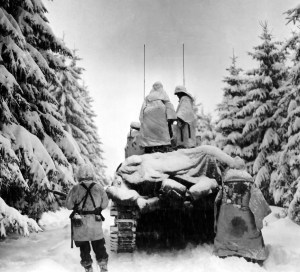 Tanks and Infantrymen of the 82nd Airborne Division, Company G, 740th Tank Battalion, 504th Regiment, push through the snow toward their objective in Belgium.