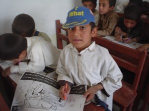 A kid coloring a PSYOP product tell them to stay away from military convoys. 